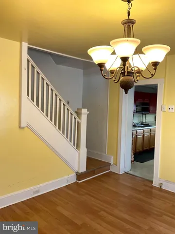 an empty room with wooden floor and sliding door