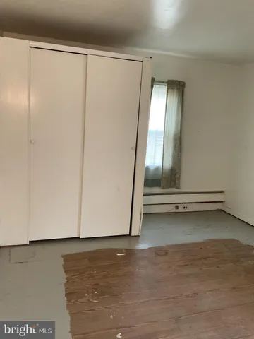 a view of backyard with small cabin and wooden fence