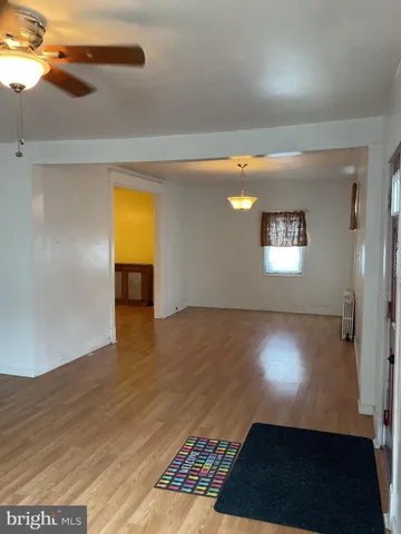 a view of a room with wooden floor and a window