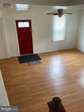 a view of a room with window wooden floor and a ceiling fan