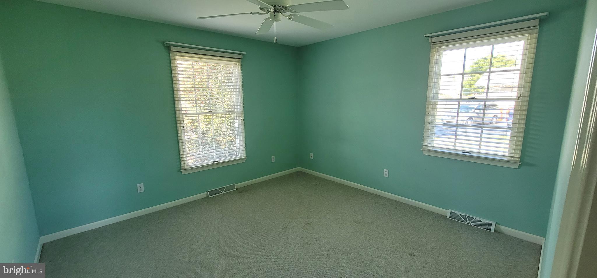 16891 Essex Road Lewes, DE 19958 - Photo 17 of 18 an empty room with a window and a ceiling fan