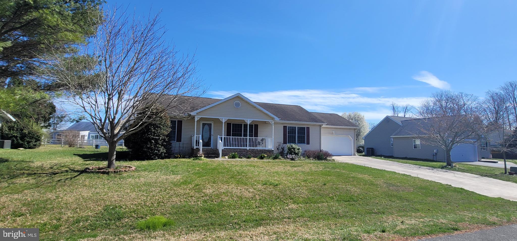 16891 Essex Road Lewes, DE 19958 - Photo 2 of 18 a view of a yard in front of a house with a large tree
