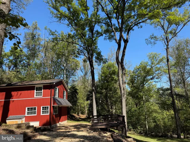 a red brick house with trees in front of it