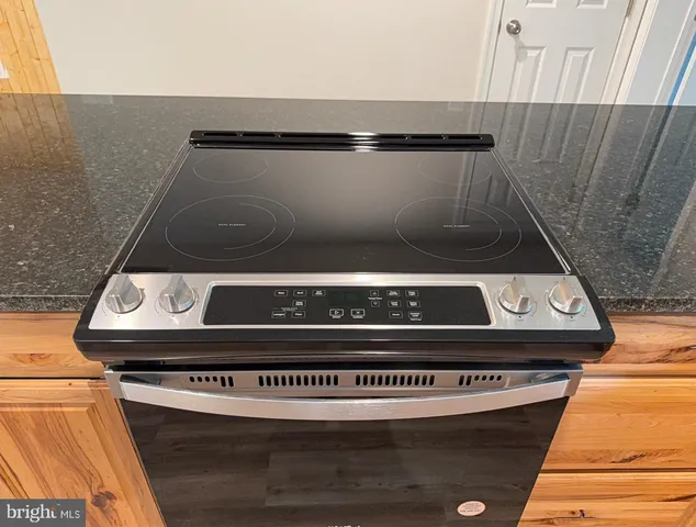 a kitchen with granite countertop a sink and a white cabinets