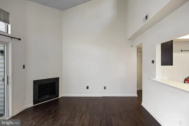 a view of a room with wooden floor and brick wall