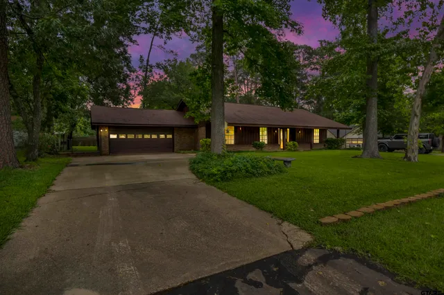 a view of a patio with a table and chairs under an umbrella