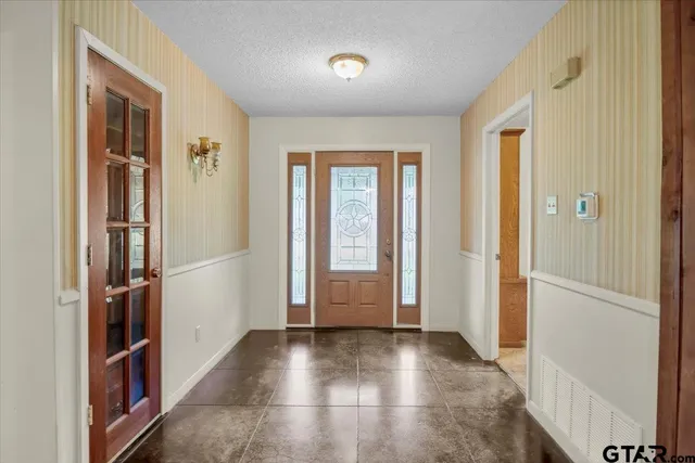 a view of an empty room with a fireplace and a window