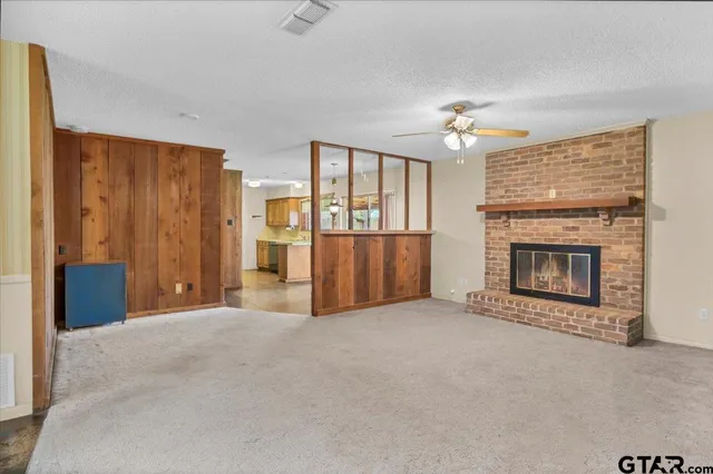 a view of an empty room with wooden floor and cabinet