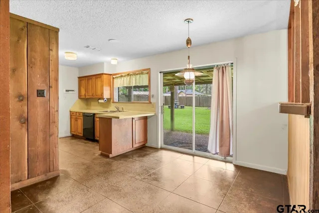 a kitchen with stainless steel appliances a stove a sink and a refrigerator