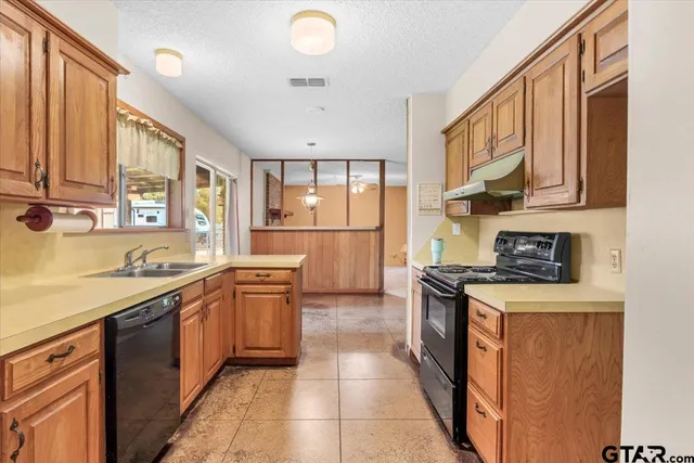 a kitchen with stainless steel appliances granite countertop a sink and cabinets