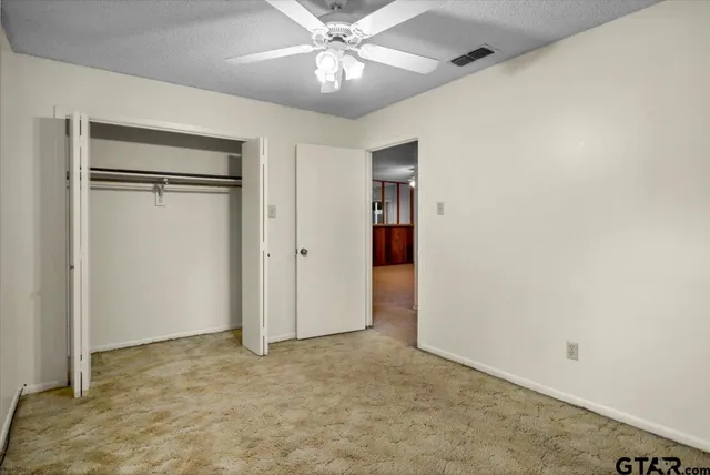 a bathroom with a sink a toilet a mirror and shower
