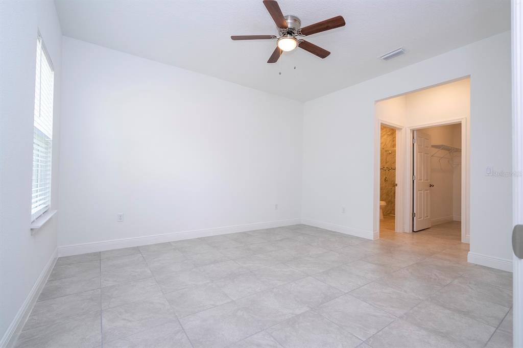 1533 West Diamond Road Citrus Springs, FL 34434 - Photo 25 of 66 an empty room with a ceiling fan and a window
