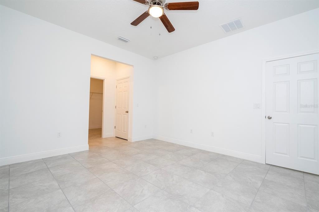 1533 West Diamond Road Citrus Springs, FL 34434 - Photo 27 of 66 an empty room with a ceiling fan and carpet