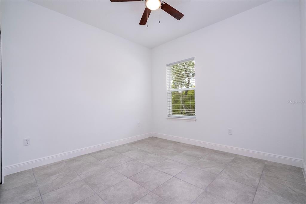 1533 West Diamond Road Citrus Springs, FL 34434 - Photo 51 of 66 an empty room with a window and a ceiling fan