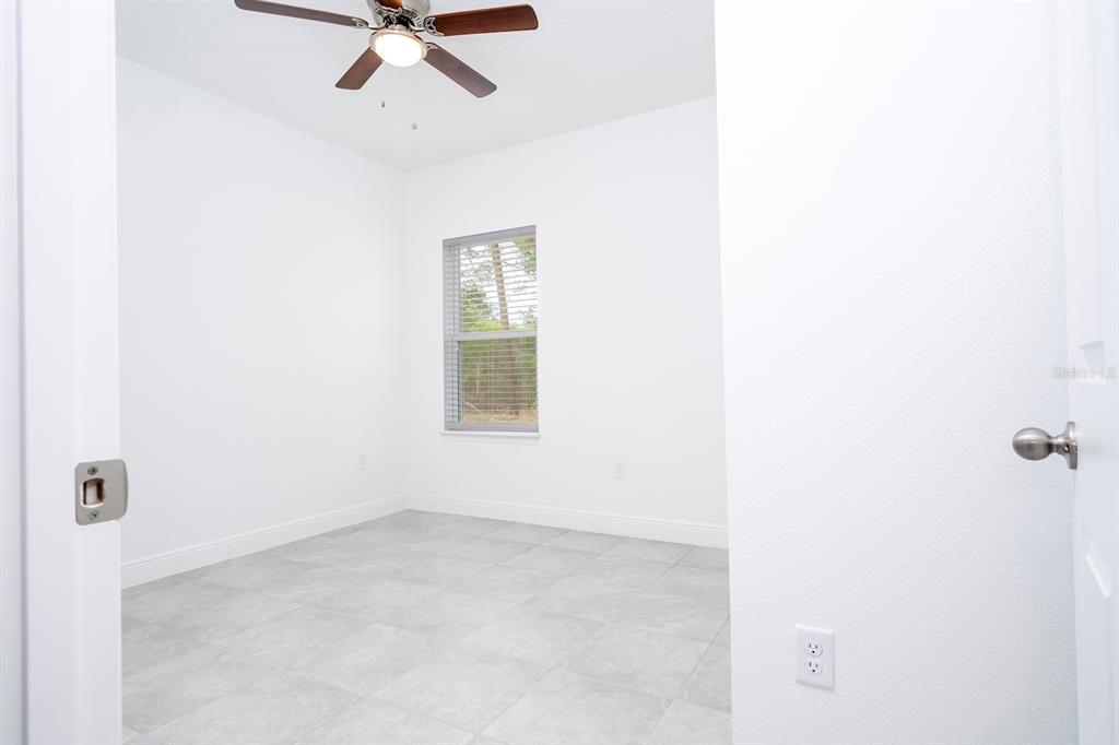 1533 West Diamond Road Citrus Springs, FL 34434 - Photo 54 of 66 an empty room with a ceiling fan and a window