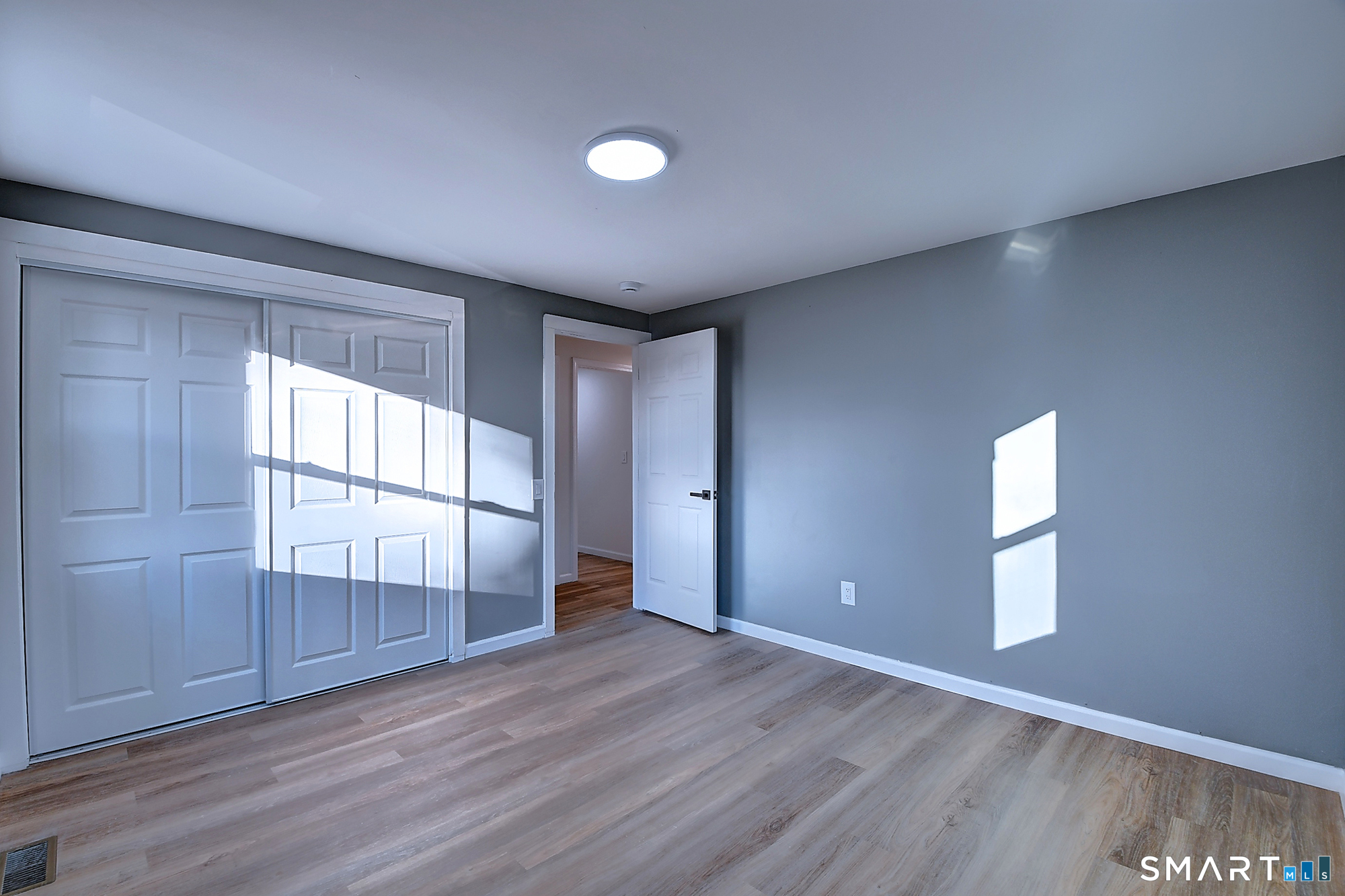 24 Dunay Road Stafford, CT 06076 - Photo 23 of 38 an empty room with wooden floor and windows