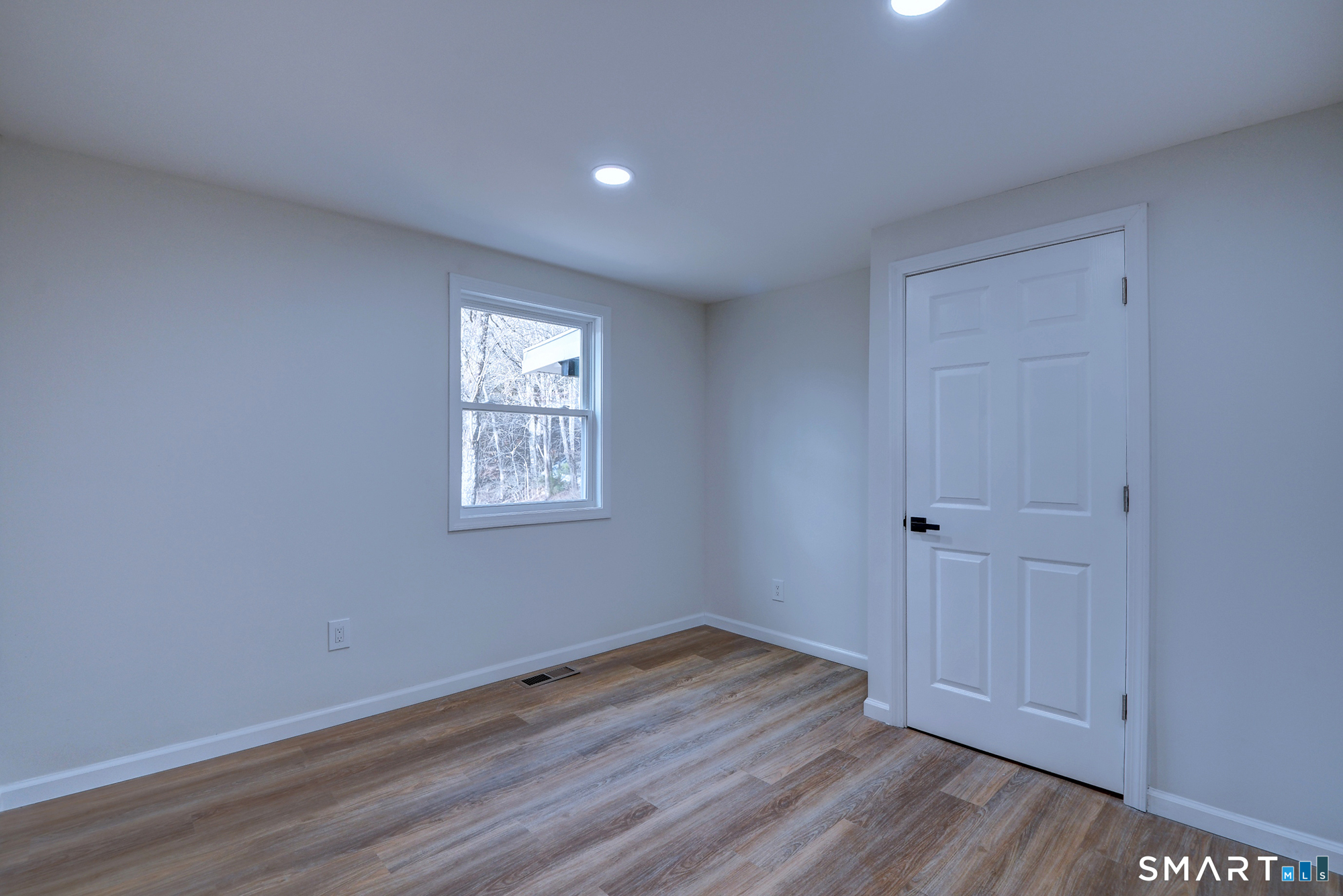 24 Dunay Road Stafford Springs, CT 06076 - Photo 28 of 38 a view of an empty room with wooden floor and a window