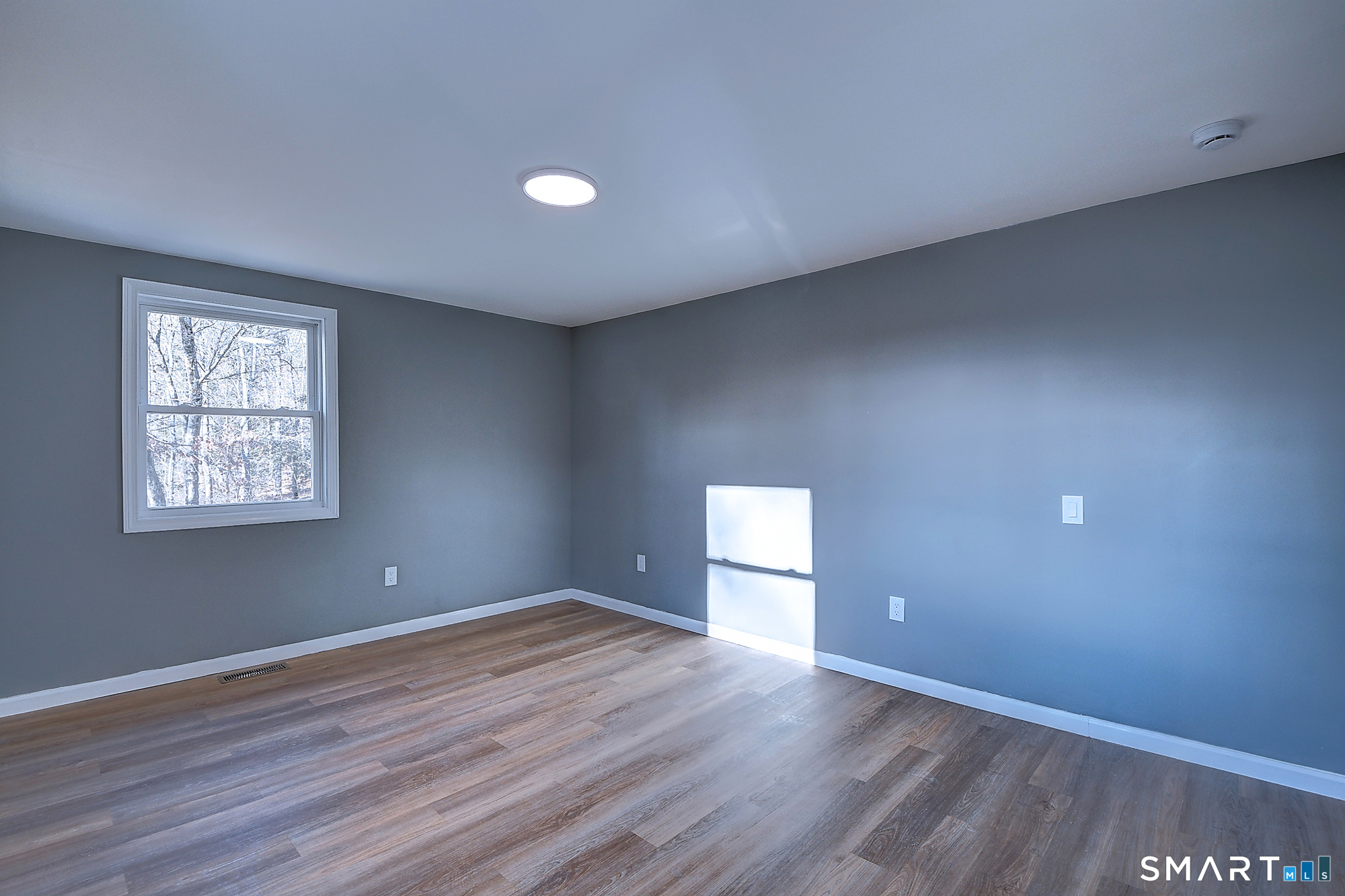 24 Dunay Road Stafford, CT 06076 - Photo 28 of 38 an empty room with wooden floor and windows