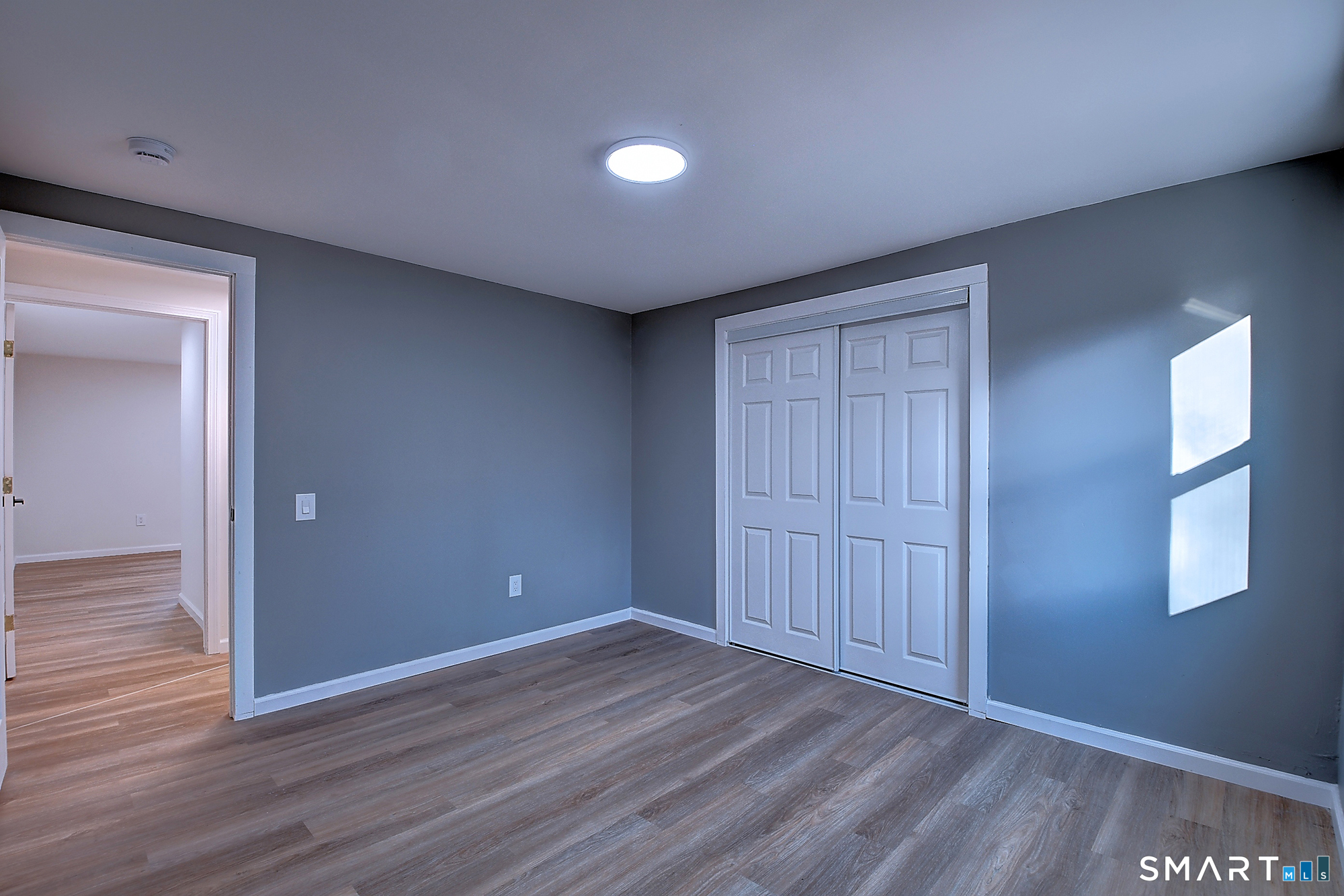 24 Dunay Road Stafford, CT 06076 - Photo 30 of 38 a view of an empty room with wooden floor and a window