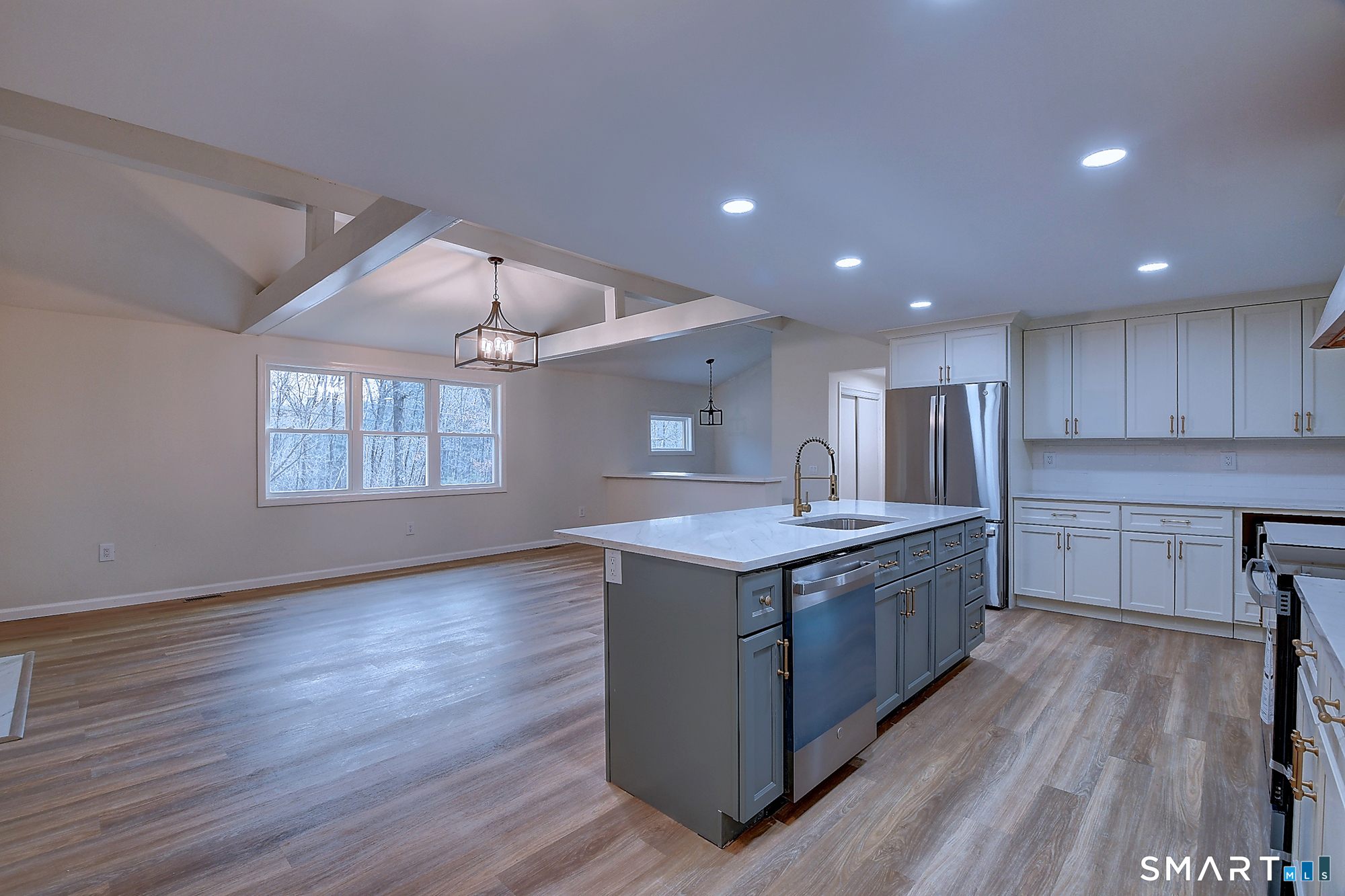 24 Dunay Road Stafford Springs, CT 06076 - Photo 6 of 38 a kitchen with kitchen island granite countertop wooden floors and white stainless steel appliances