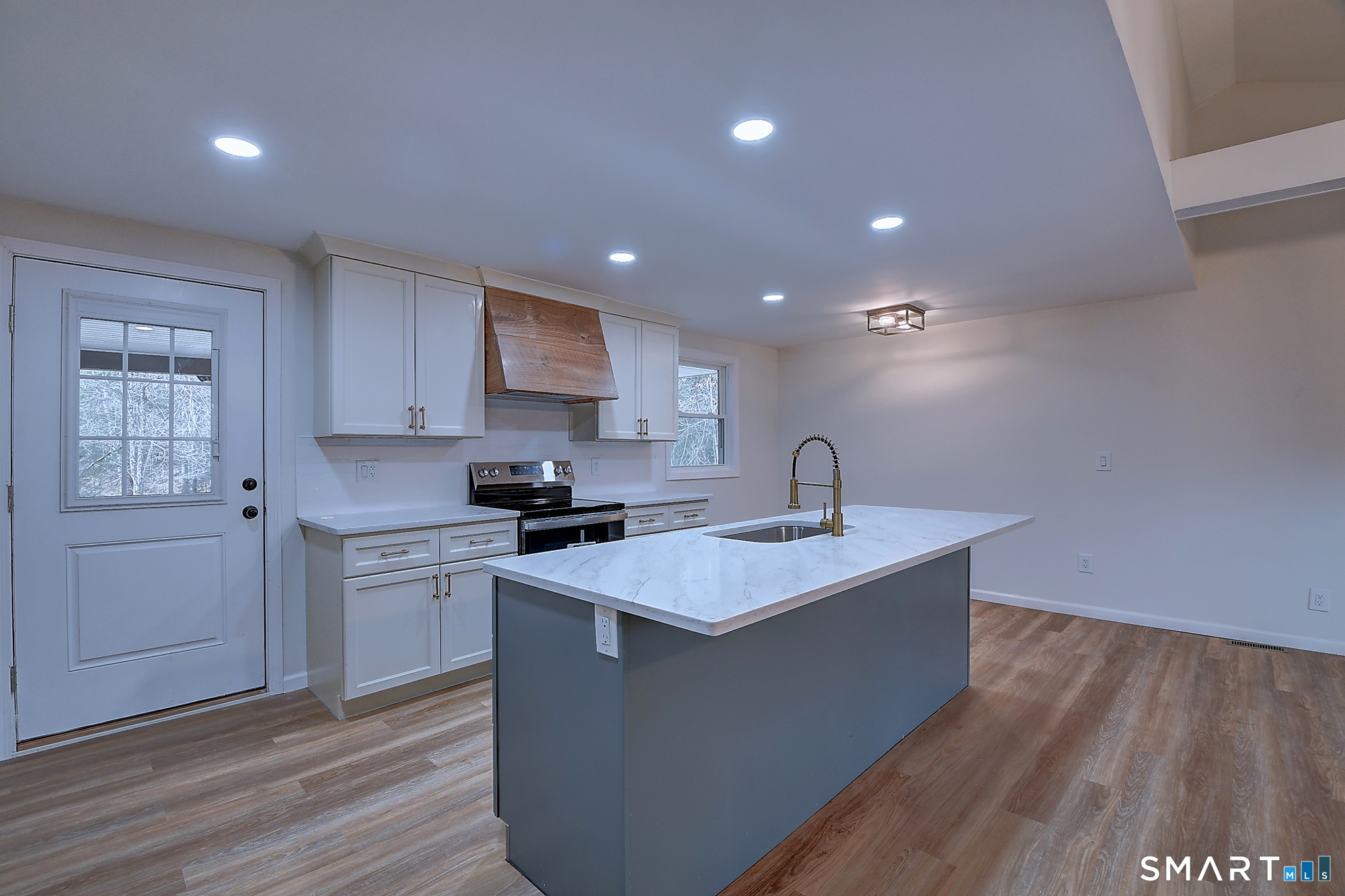 24 Dunay Road Stafford Springs, CT 06076 - Photo 9 of 38 a kitchen with a sink cabinets and wooden floor