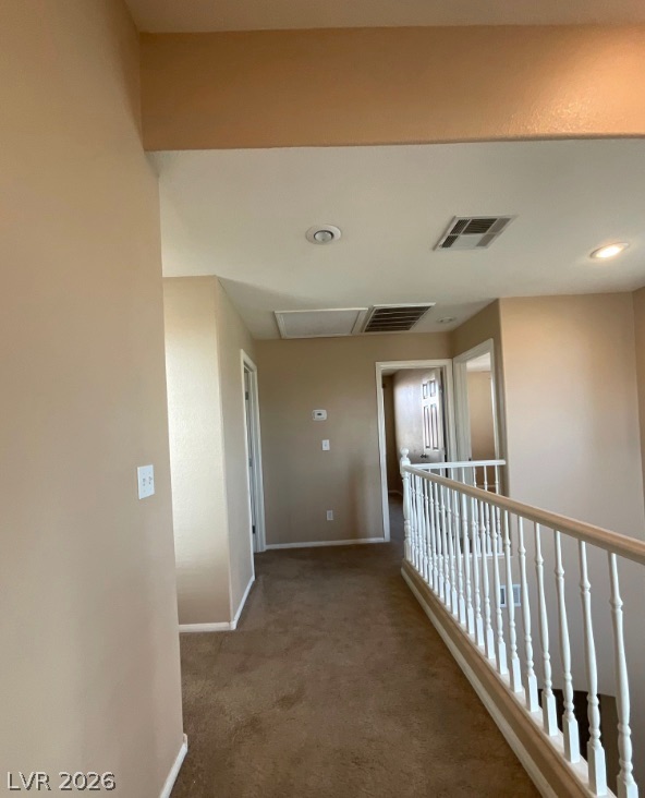 10841 Paradise Road Henderson, NV 89052 - Photo 12 of 35 A well-lit second-story landing offers easy access to multiple rooms, highlighted by carpeted floors and clean walls.