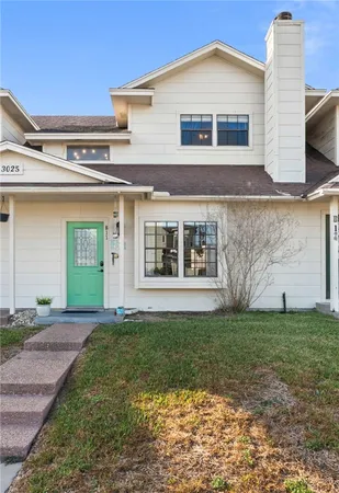 a view of a white house with a big yard and large trees