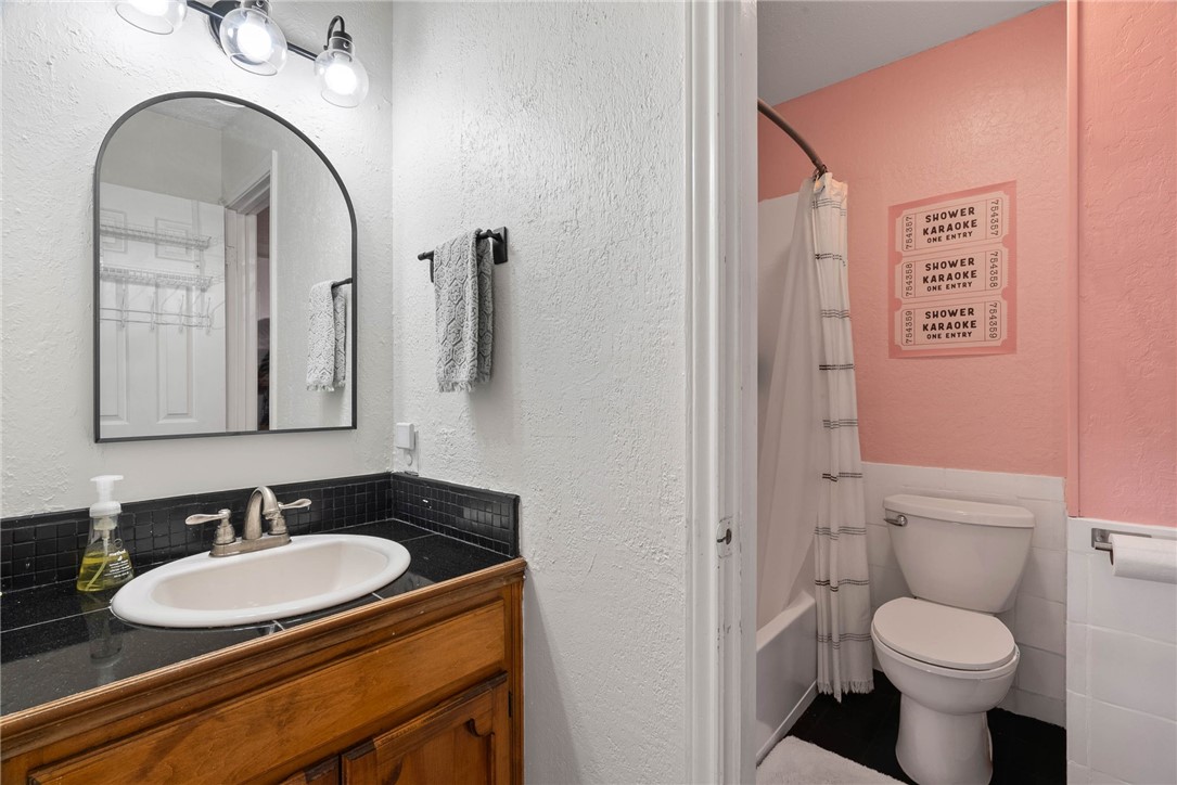 3025 Quail Springs Road, Unit B11 Corpus Christi, TX 78414 - Photo 11 of 20 a bathroom with a granite countertop toilet sink and mirror