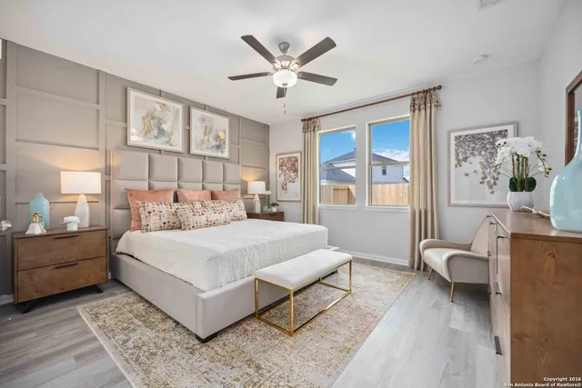 a bedroom with a large bed and a window