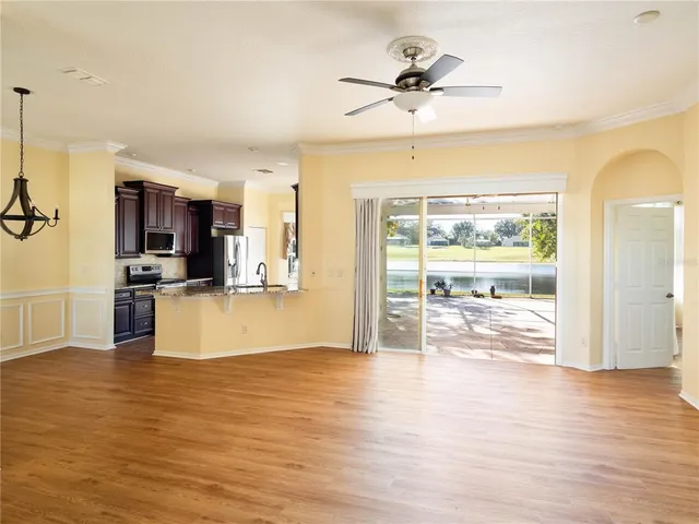 a view of kitchen with livingroom and wooden floor