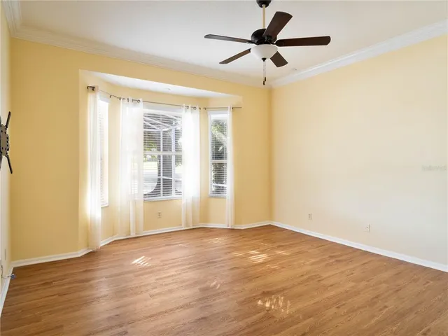 a view of a livingroom with wooden floor and a ceiling fan