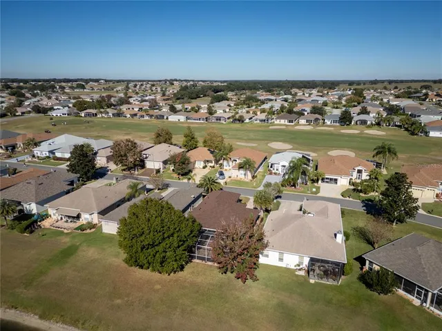 an aerial view of a house with a lake view