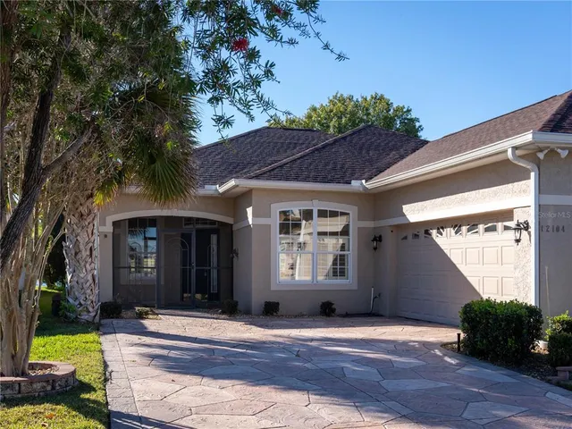 a view of house with yard and outdoor seating