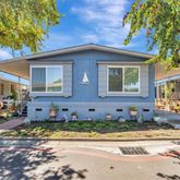 a view of a house with a yard and sitting area