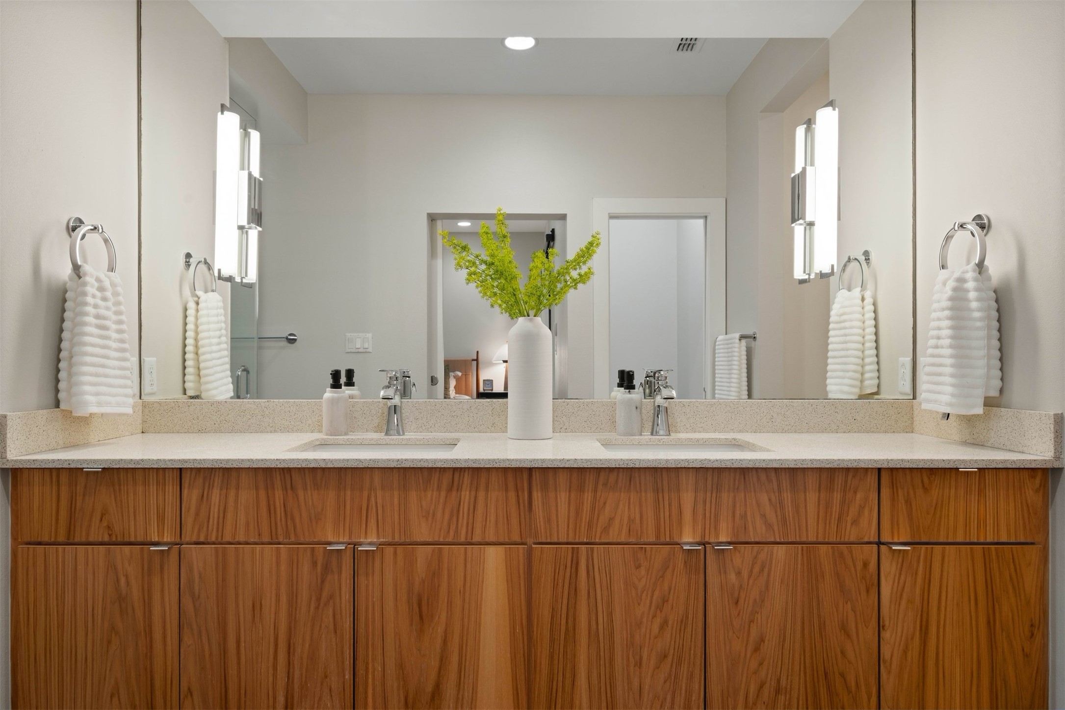 3921 Threadgill Street Austin, TX 78723 - Photo 25 of 36 The primary ensuite bathroom includes dual vanity sinks, giving two people plenty of counter space and drawer storage to prepare for the day without getting in each other's way