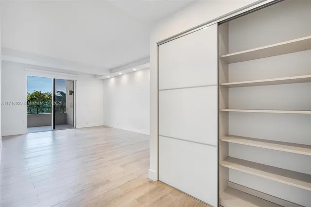 a view of walk in closet with empty racks
