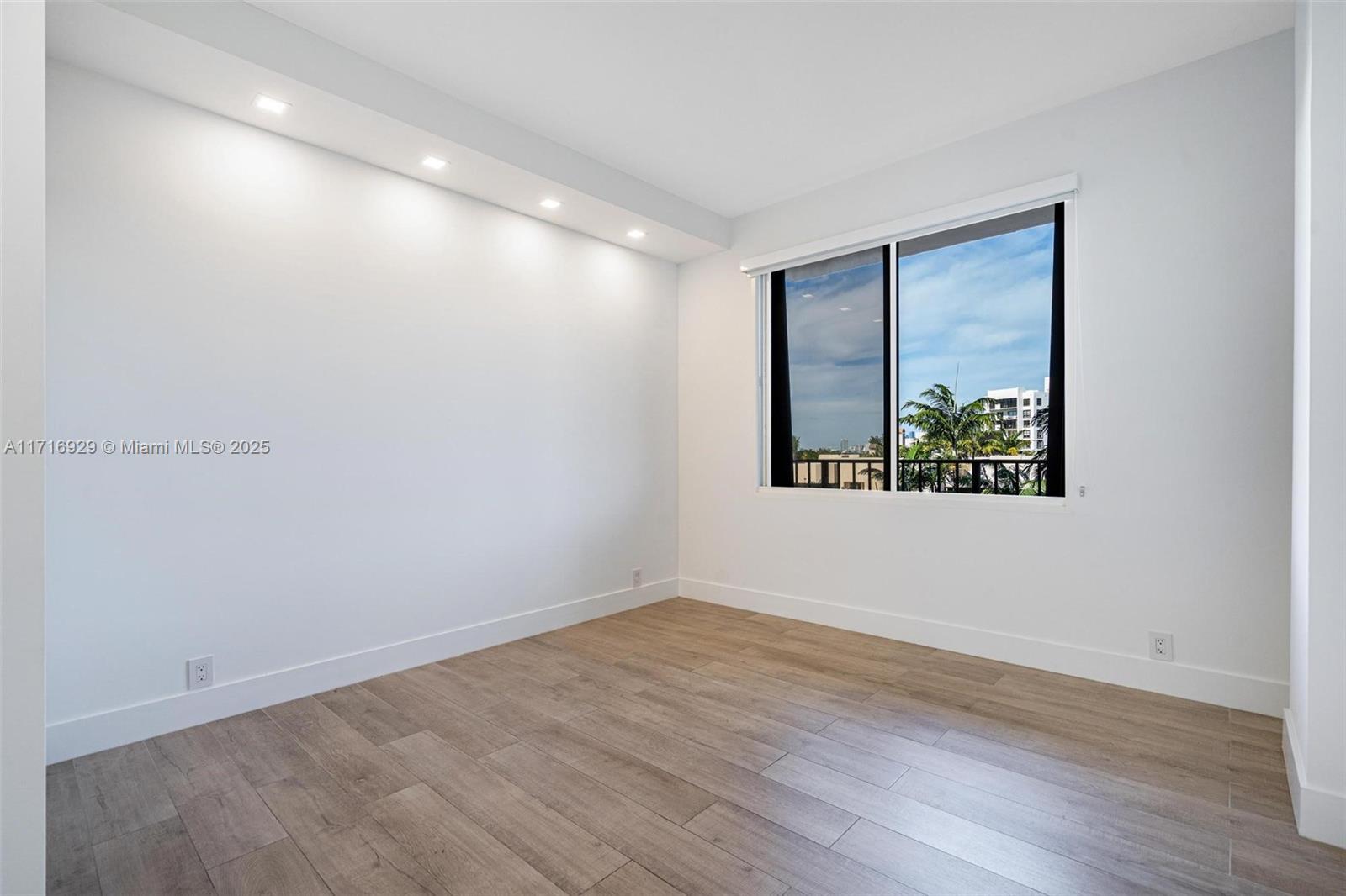 151 Crandon Boulevard, Unit 534 Key Biscayne, FL 33149 - Photo 26 of 49 a view of an empty room with wooden floor and a window