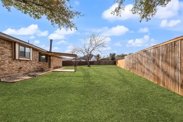 a view of a backyard with large trees