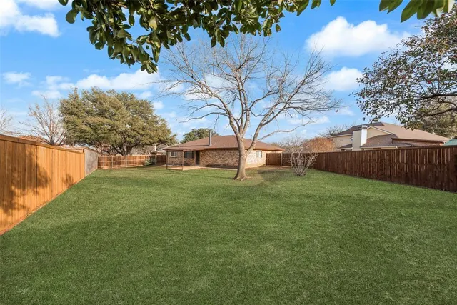 a view of a backyard with large trees