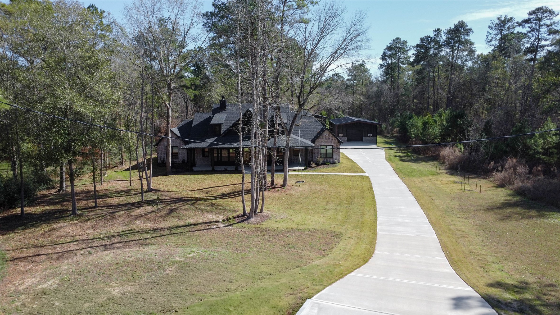 0 Bighorn Road Huntsville, TX 77340 - Photo 20 of 22 a view of a swimming pool with potted plants and large trees