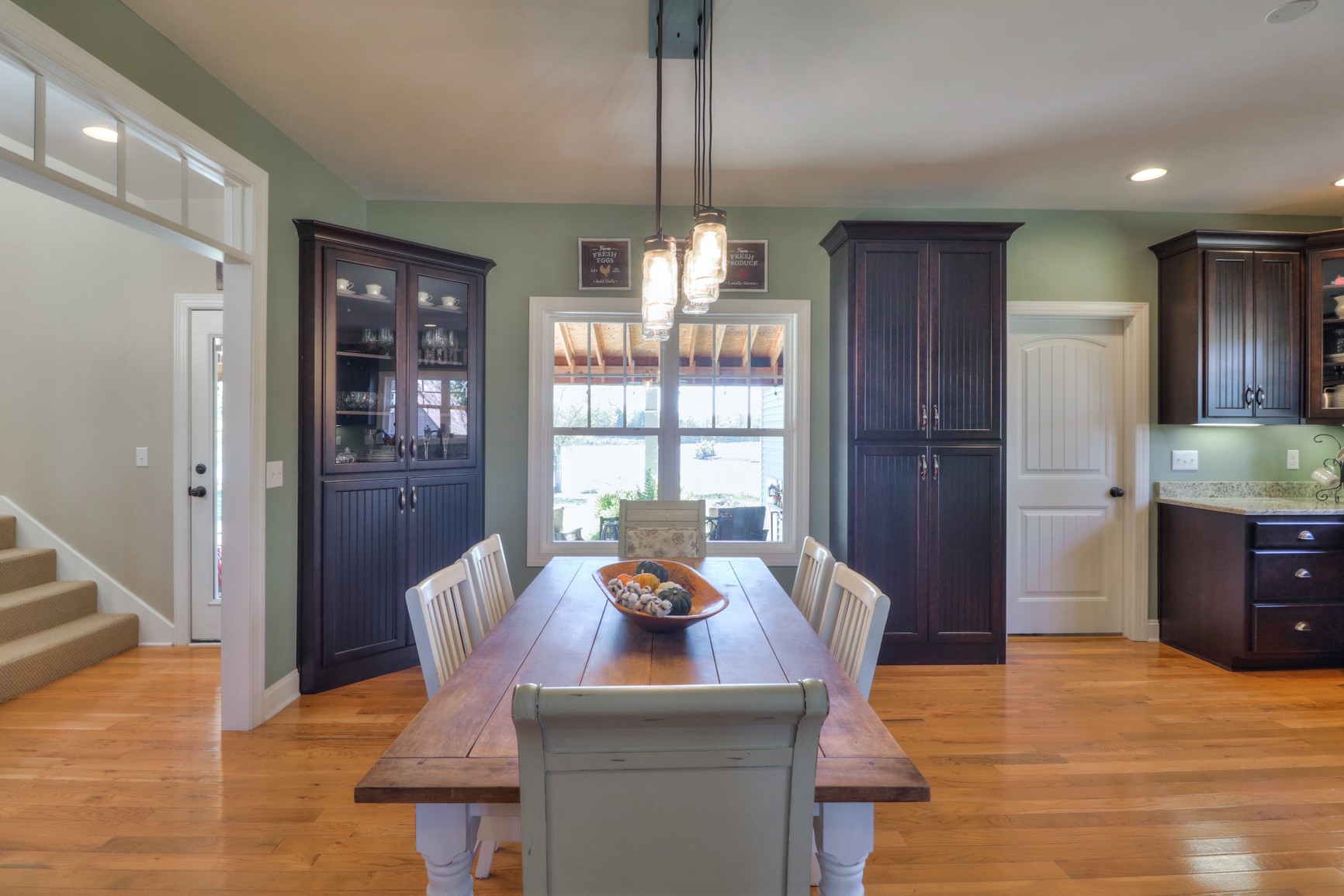 4275 Cairo Bend Road Lebanon, TN 37087 - Photo 14 of 41 a view of a dining room with furniture a chandelier and wooden floor