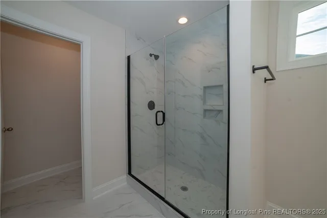 a bathroom with a glass shower door