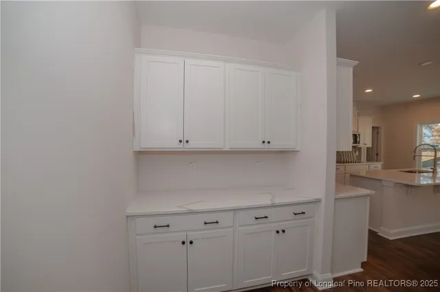 a kitchen with white cabinets and a sink