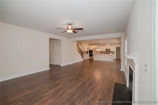 a view of a livingroom with furniture and a ceiling fan