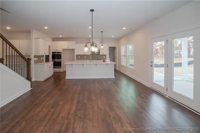 a large kitchen with lots of counter space a sink and appliances