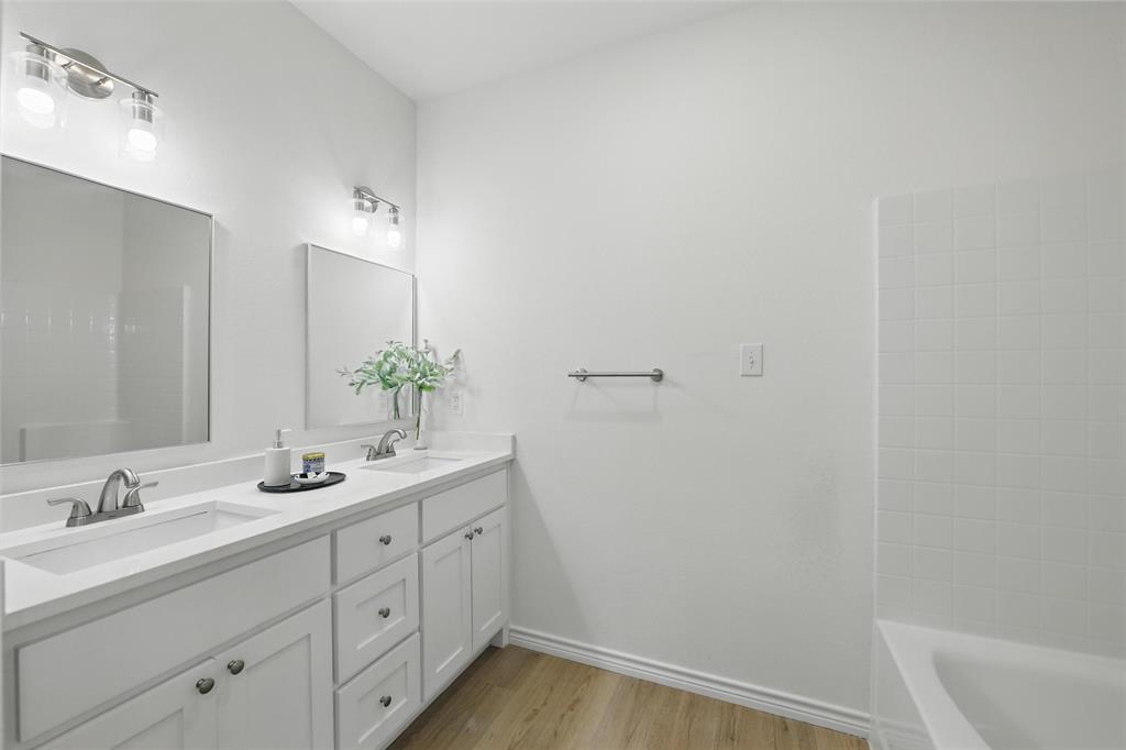 112 Cedar Shadow Lane Whitney, TX 76692 - Photo 24 of 28 a bathroom with a sink and a mirror with bathtub