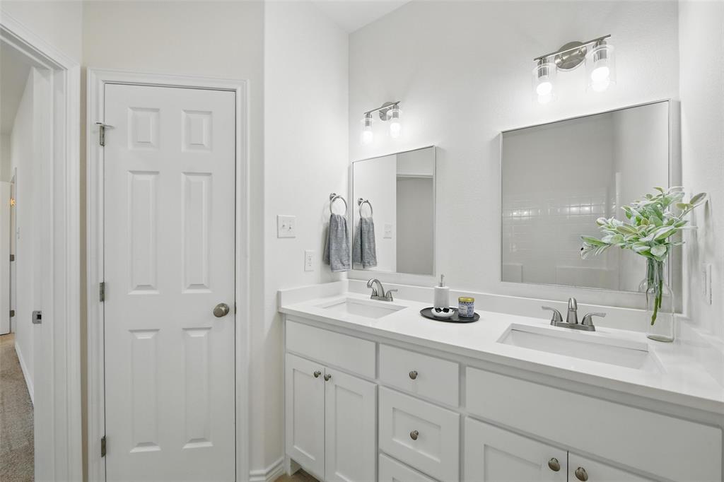 112 Cedar Shadow Lane Whitney, TX 76692 - Photo 25 of 28 a bathroom with double vanity sinks a vanity and a mirror