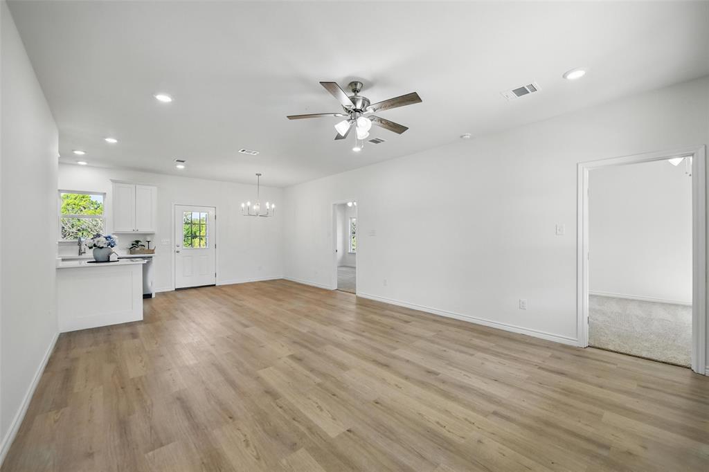 112 Cedar Shadow Lane Whitney, TX 76692 - Photo 4 of 28 a view of an empty room and kitchen with ceiling fan