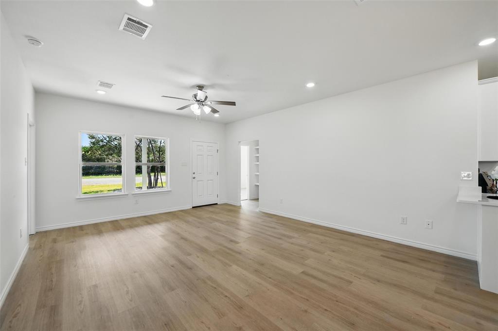 112 Cedar Shadow Lane Whitney, TX 76692 - Photo 6 of 28 an empty room with wooden floor and window