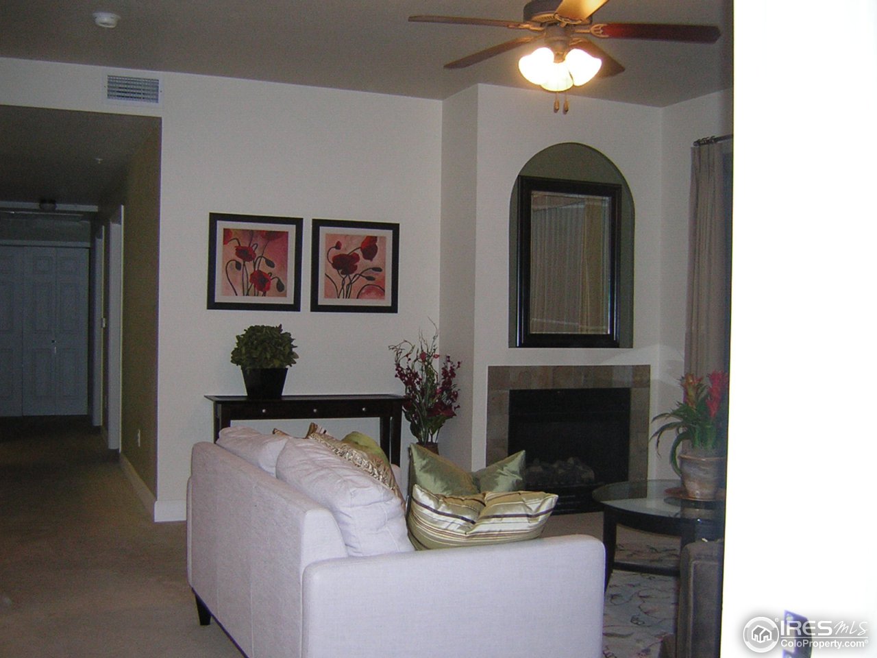 4500 Baseline Road, Unit 2207 Boulder, CO 80303 - Photo 5 of 16 a living room with furniture a fireplace and a chandelier